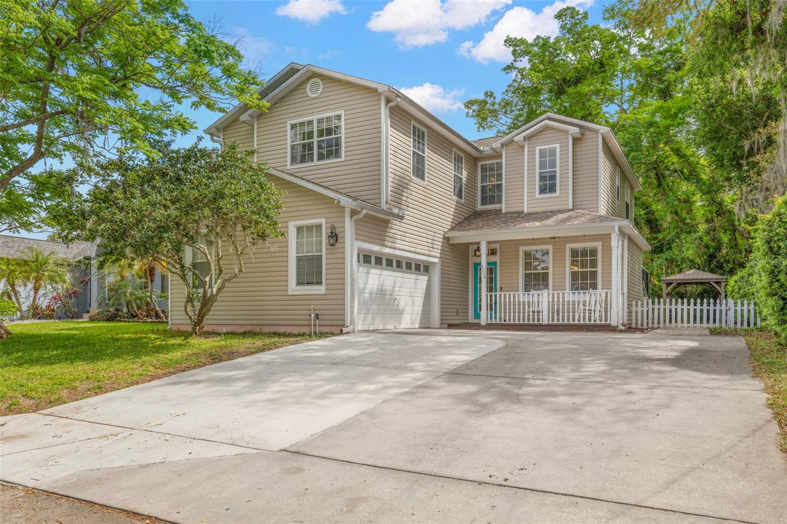 This move-in-ready home features a side-facing two-car garage and an oversized driveway with ample parking. A covered front porch creates a welcoming entry. 2021 roof and 2021 AC, adding peace of mind from day one.