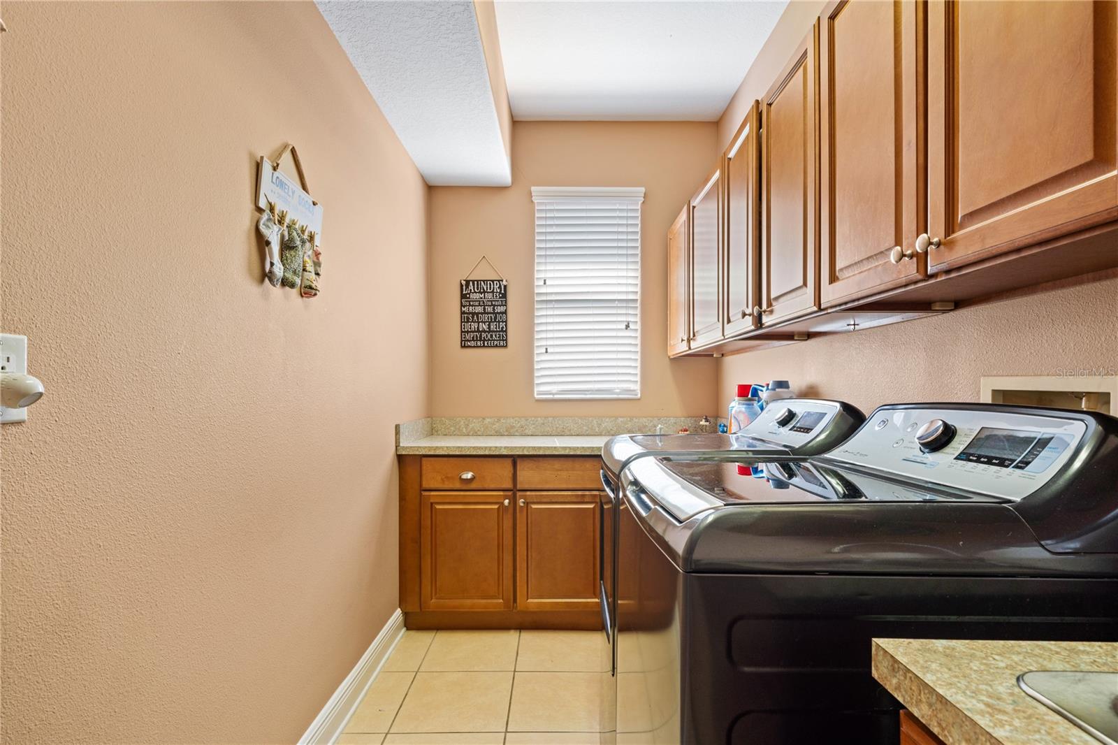 Spacious laundry room with sink and extra storage.
