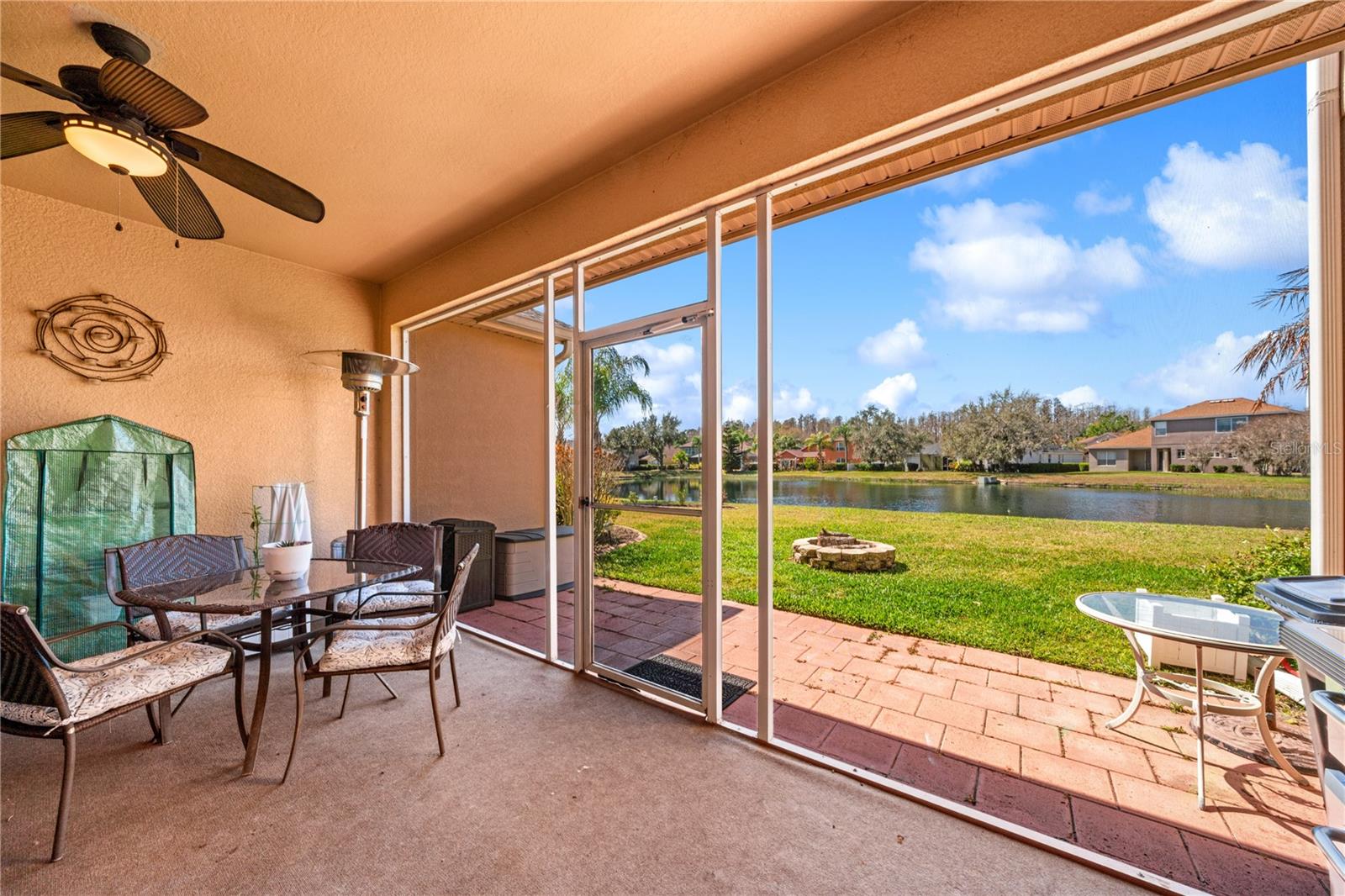Screened Lanai with serene view of pond and spacious back yard