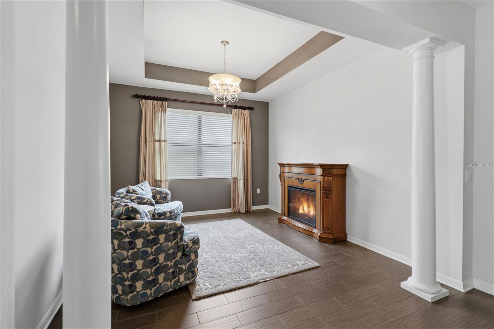 Elegant flex space featuring tray ceilings and decorative columns, ideal for a formal living room, sitting area, or additional dining space to suit your lifestyle.