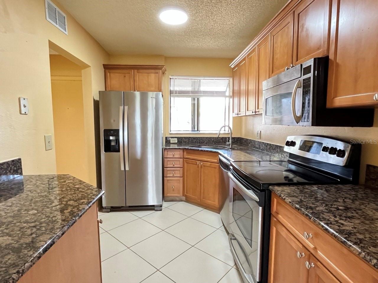 Kitchen with Stainless Appliances & Solid Wood Cabinetry