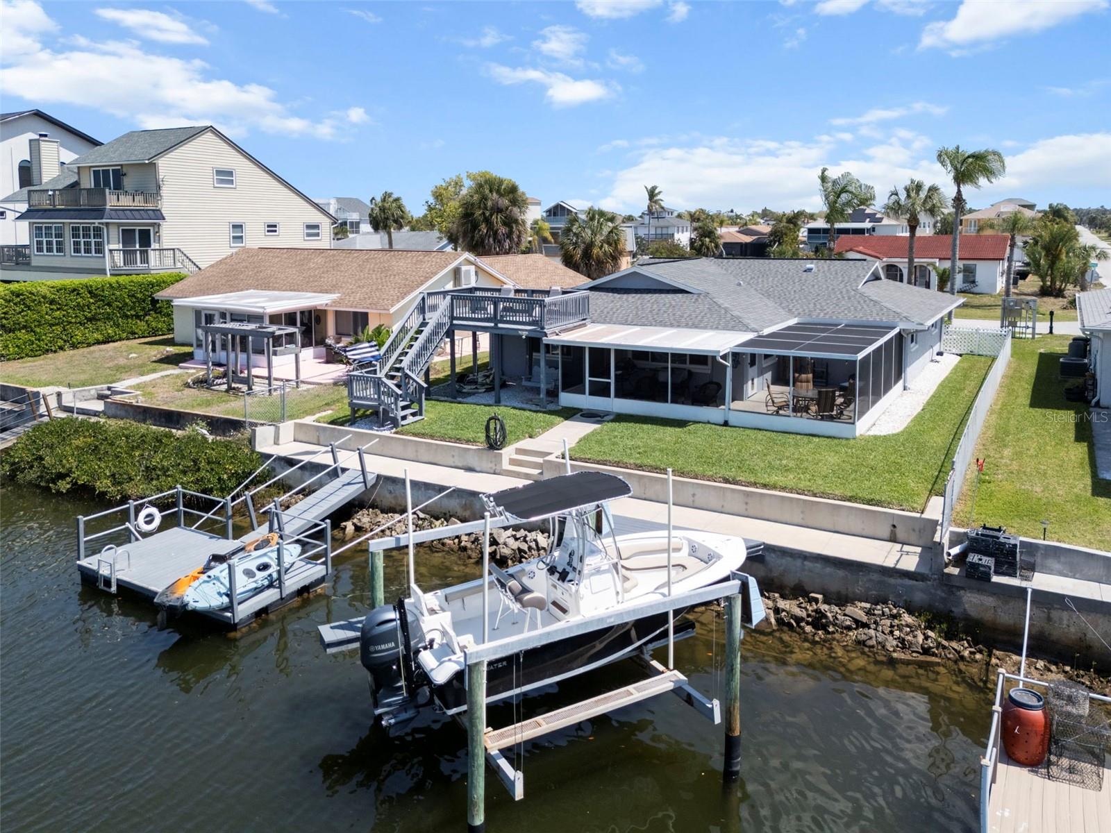 Rear of Home Featuring Floating Dock, Boat Lift and Dock, 60ft Seawall