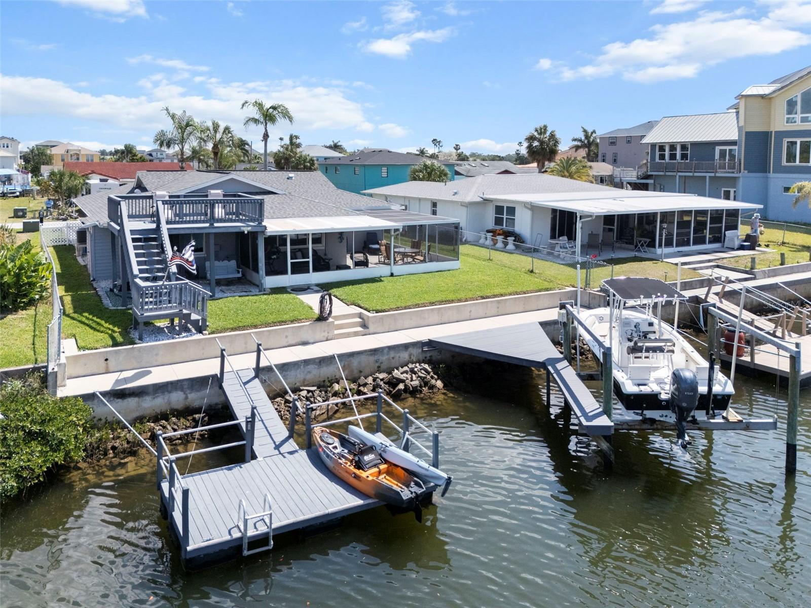 Rear of Home Featuring Floating Dock, Boat Lift and Dock, 60ft Seawall