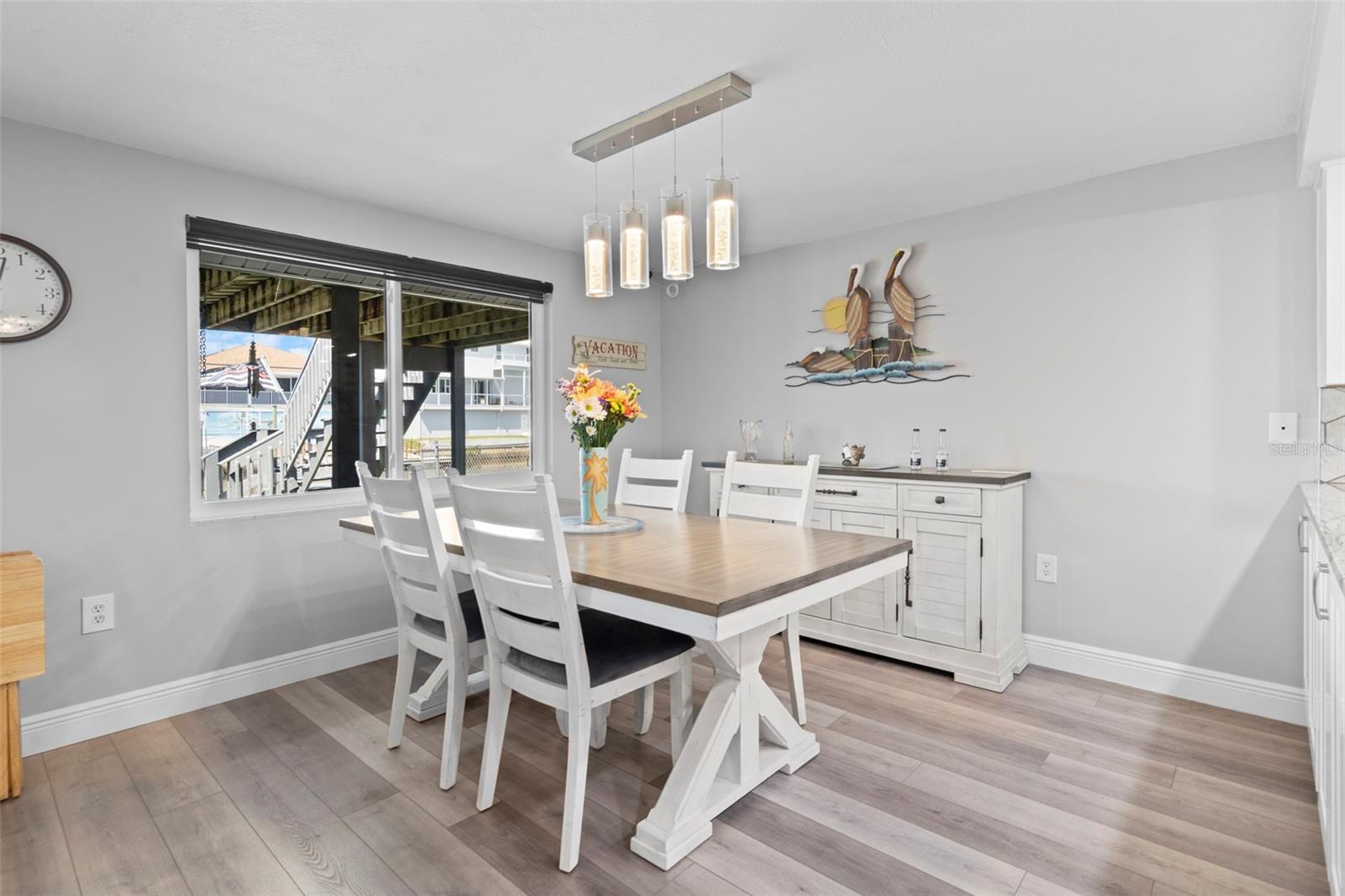 Dining Room Overlooking Canal with NEW Flooring and 2019 Hurricane Impact Windows