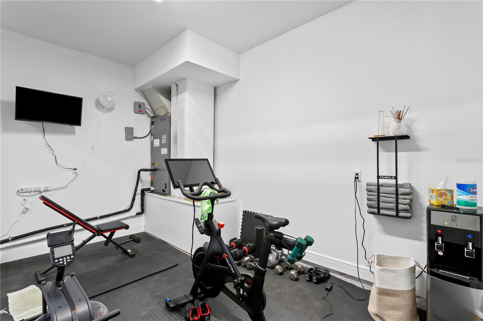 The tandem portion of the garage is climate controlled and converted to an expercise space