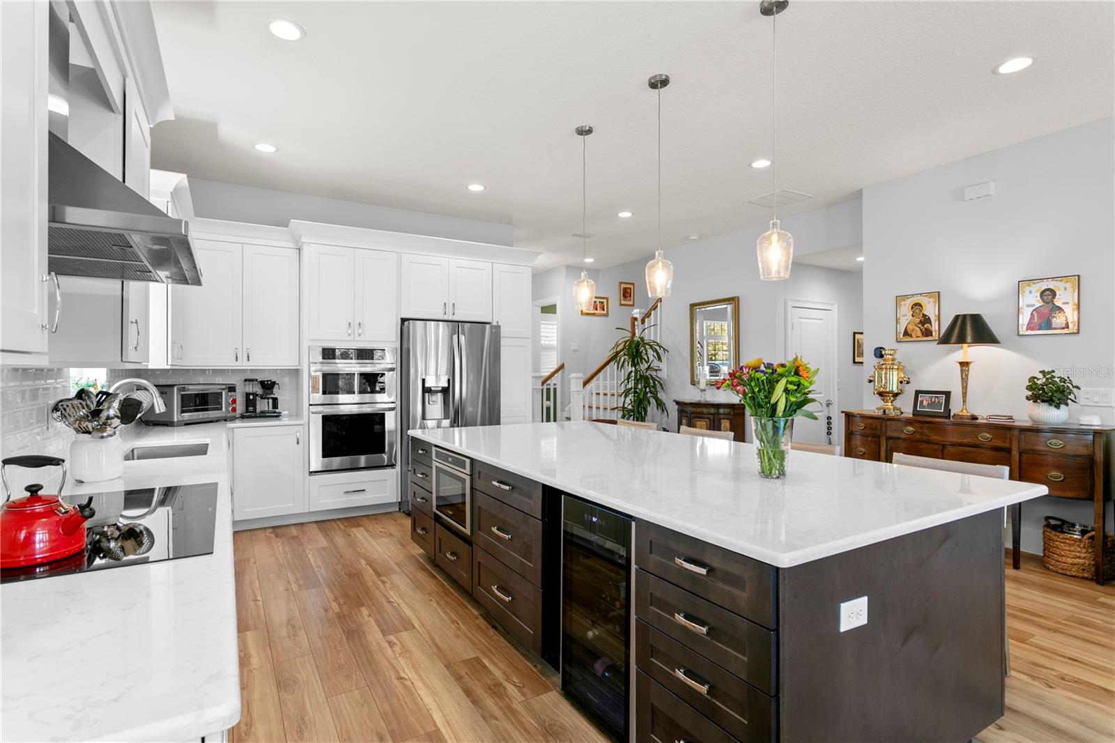 A convenient wine refrigerator and microwave nest in the center island