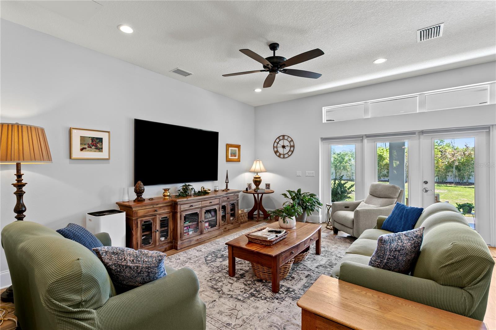 This comfortable great room with French doors provides loads of natural light into the home