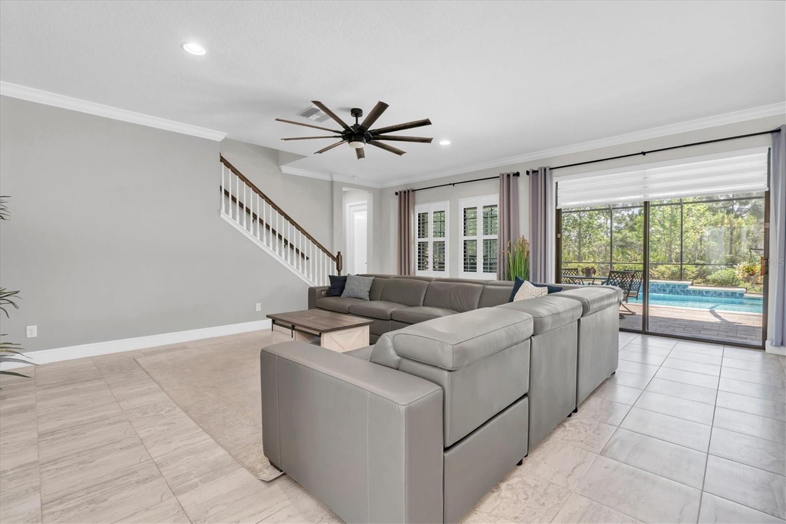 LIVING ROOM OVERLOOKING POOL & TREES