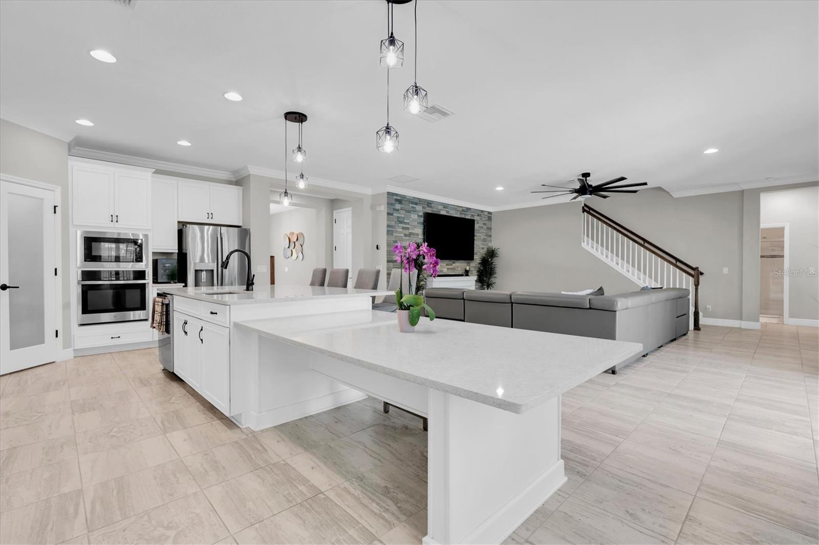 SPACIOUS ISLAND SEATS 4 BARSTOOLS AND EXENDED QUARTZ TABLE FOR CAUAL DINING