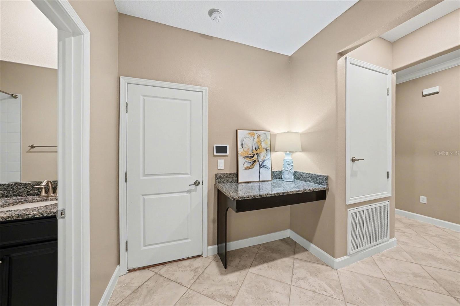 This open area with work/storage station is conveniently located in the center of the house, on the way to the Garage. It is perfect place for the home computer and storage for coats and keys.