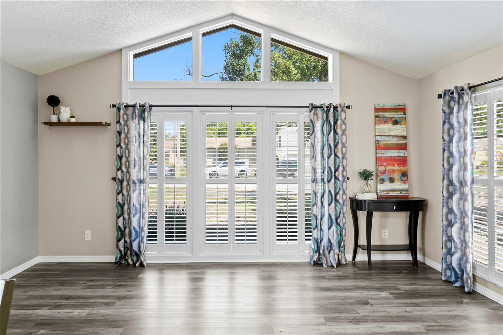 Living room with large windows and vaulted ceiling