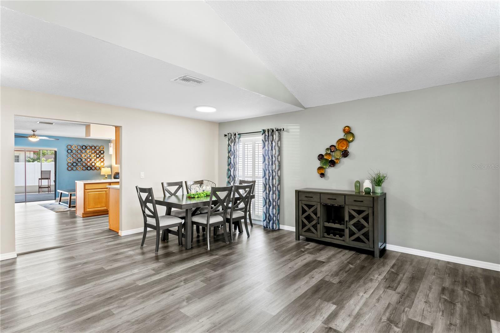 View from living room to dining room and into kitchen and family room