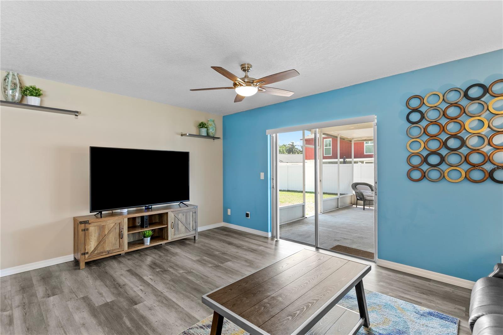 Family room with glass sliders to covered rear porch and fully fenced rear yard