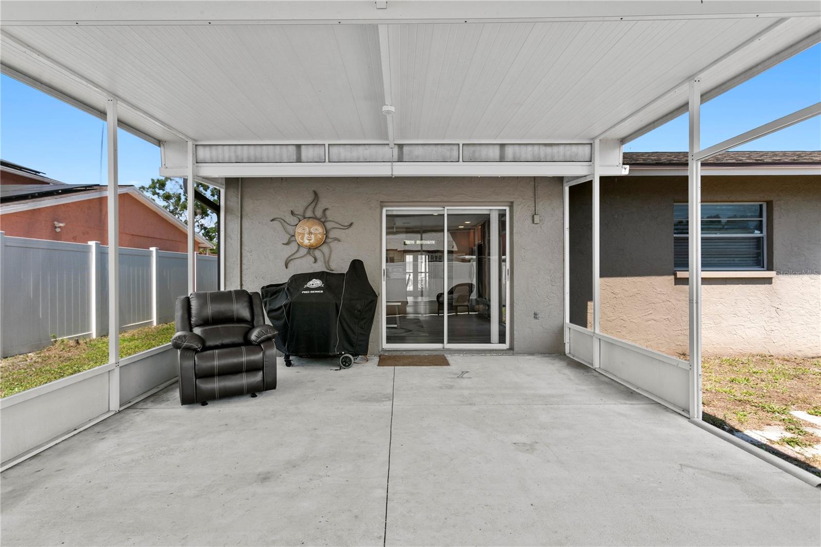 Covered rear patio is fully screened