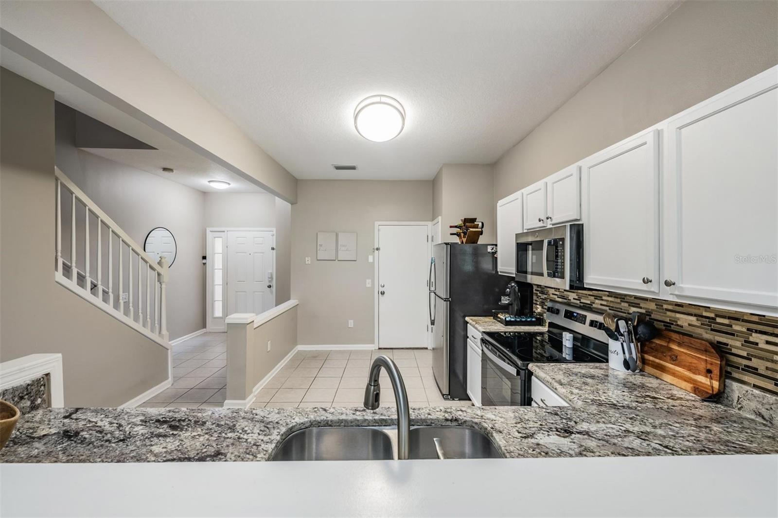 Front door to the left, private garage door on the right.