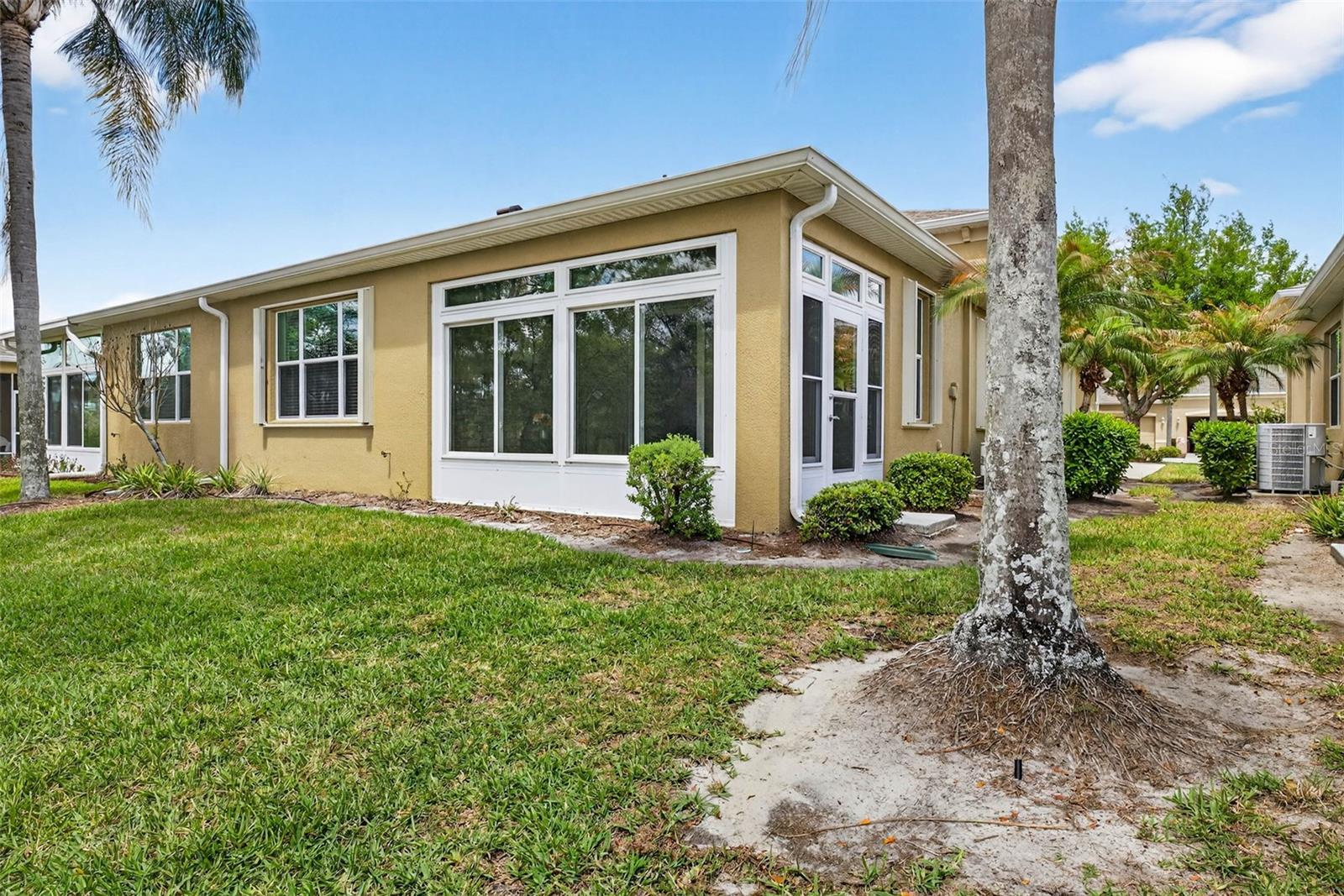 Exterior of sunroom and back of villa complete with gutter system.