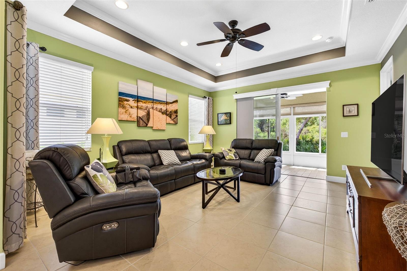 Living area with large sliding glass doors with views of Little Manatee River Park directly out the back of the lanai.