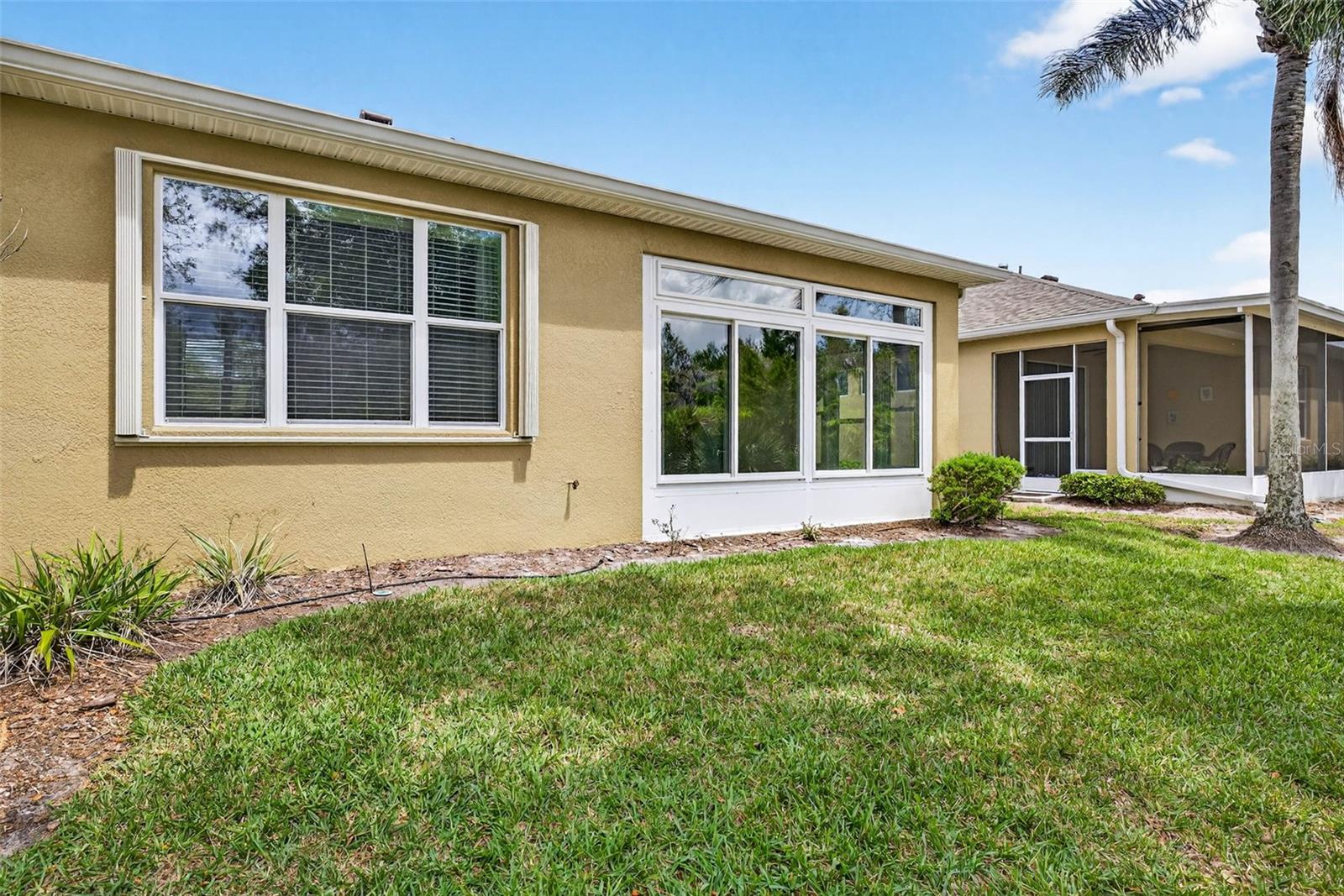 Sunroom and primary bedroom window. Home comes with convenient accordian shutters for exterior windows.