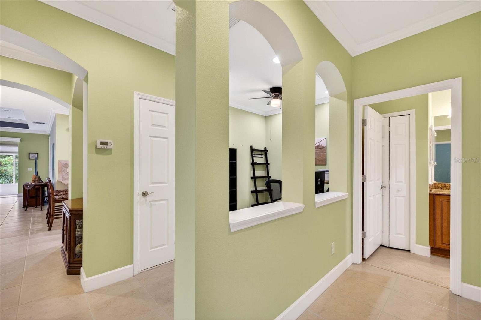 Office/Den area with hallway leading to secondary bathroom