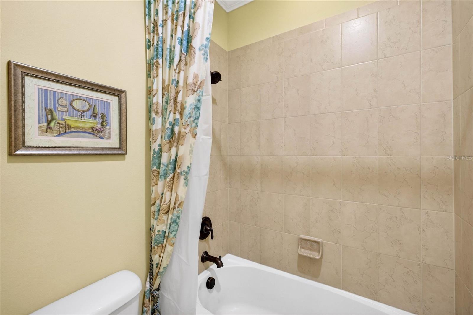Secondary bathroom with tub/shower combination.