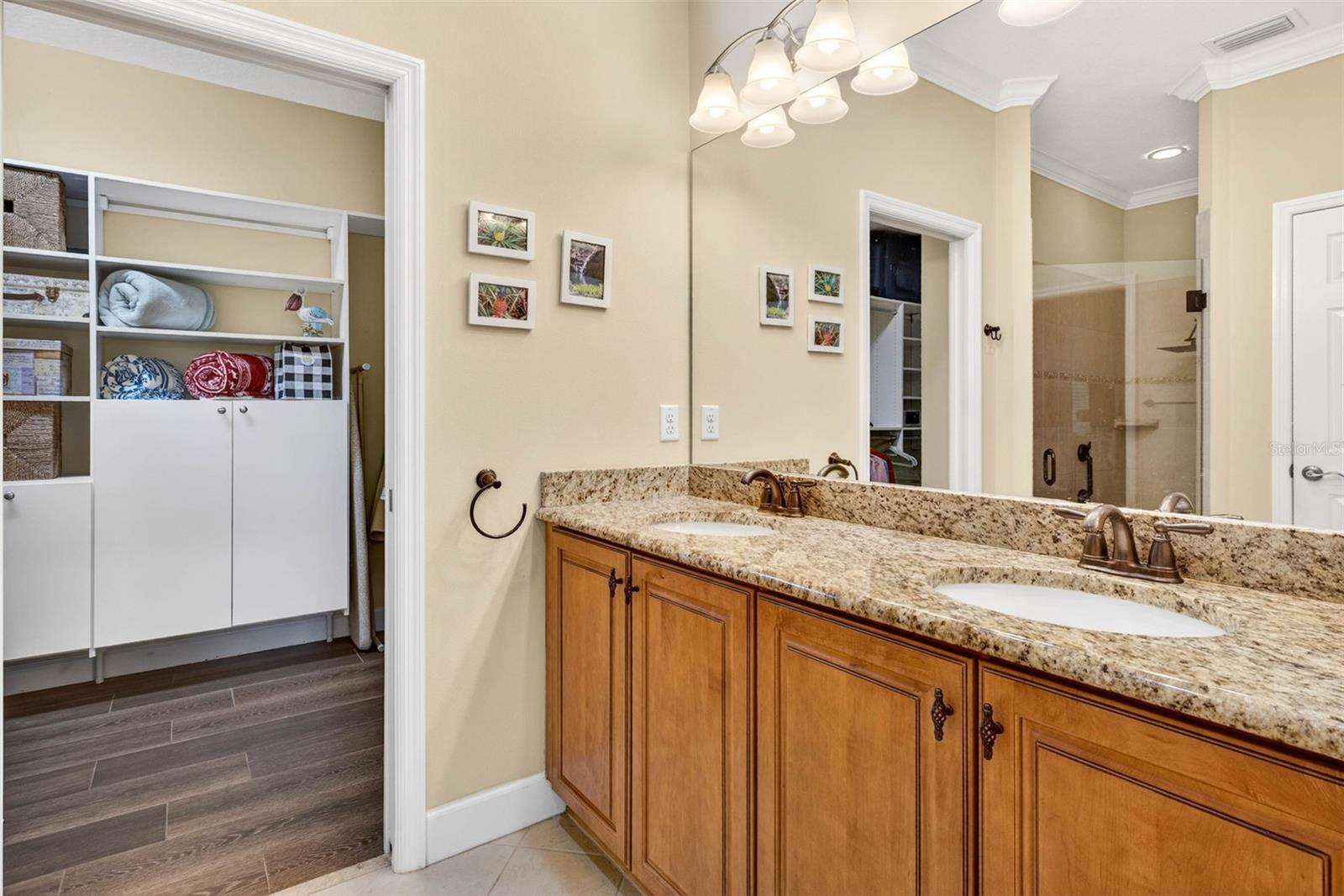 Comfort height vanity with dual sinks. Walk in closet features built in cabinets and shelving.