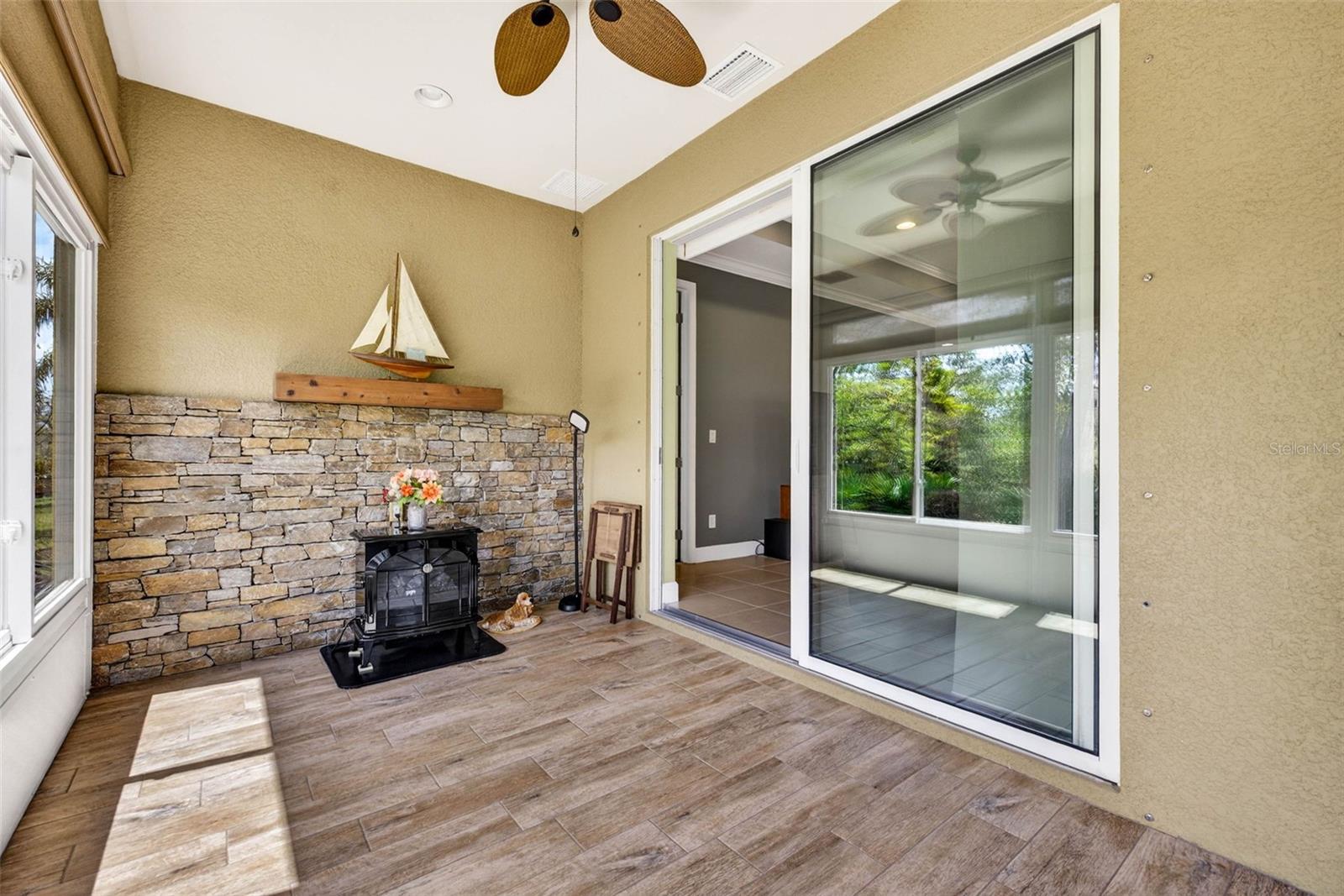 Tile flooring throughout air conditioned sun room. Sliding doors enter to main living area.