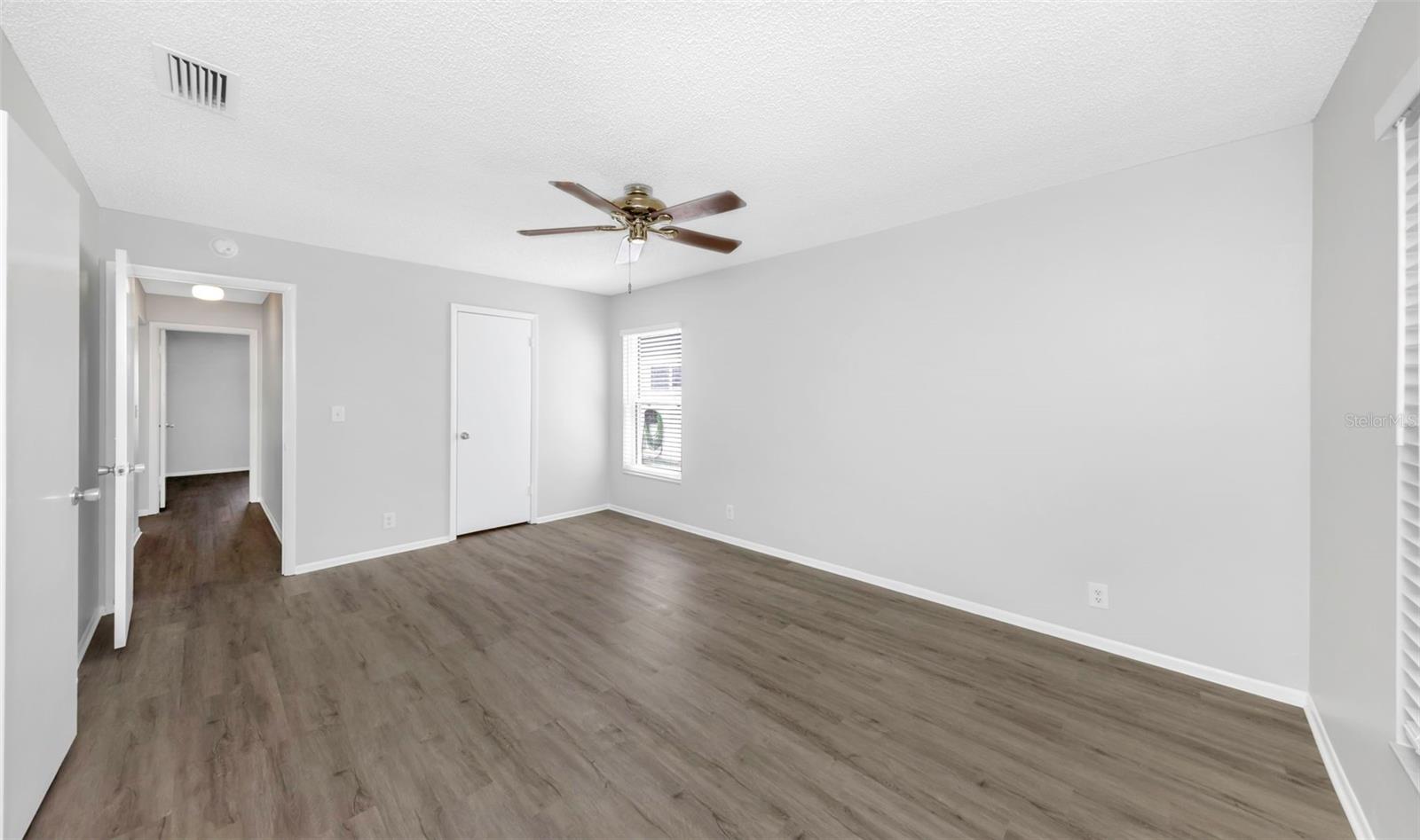 Hallway to Guest Bathroom and Bedroom on left / Closet door on right