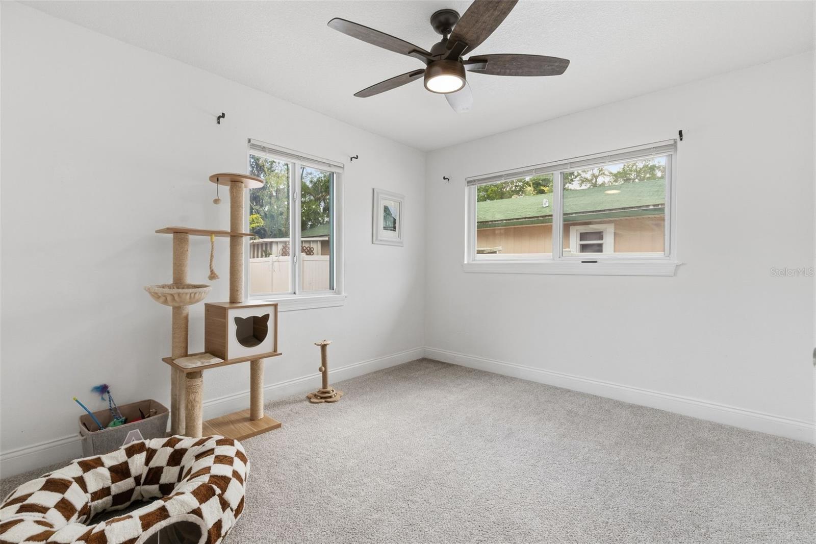 Third bedroom with ceiling fan + natural light