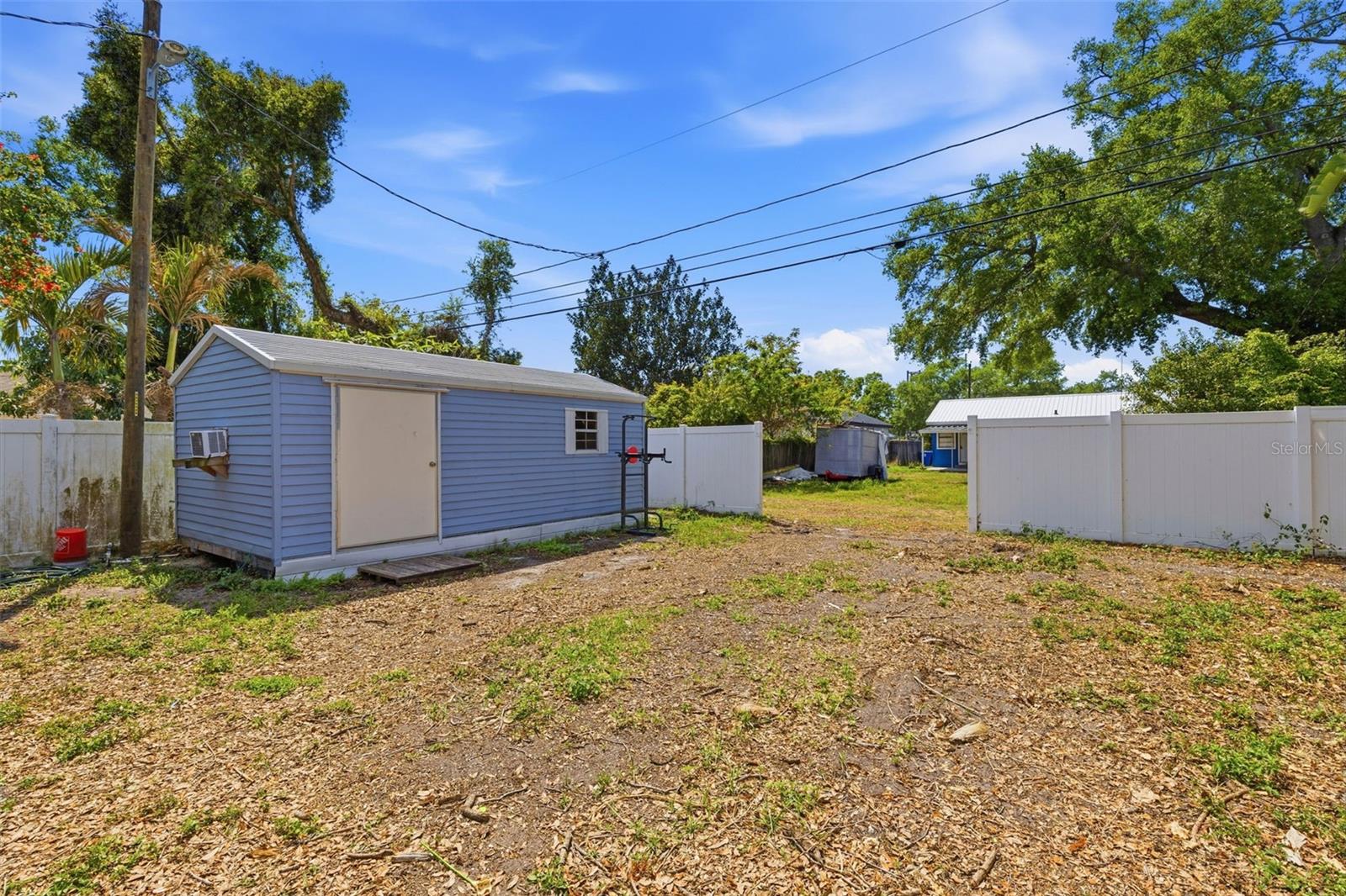 Large yard with two storage sheds + open space