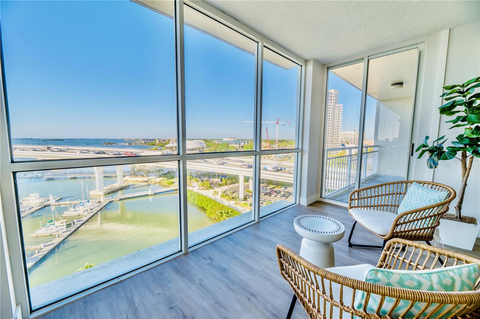 (Left to Right) Floor-to-Ceiling Windows in Living Room into Balcony of Bedroom 2
