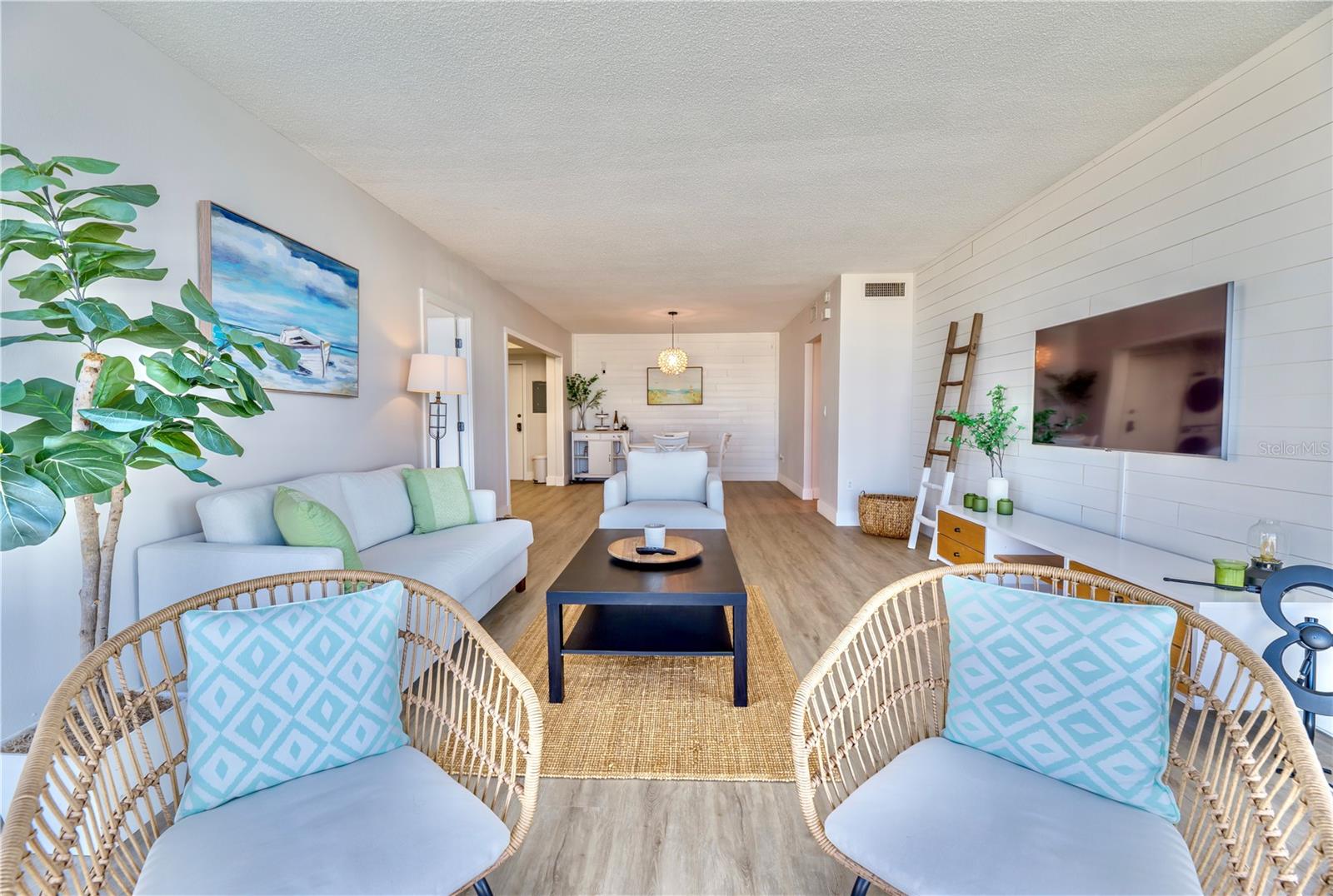 Living Room view opposite view. (Left to Right) 2nd Bedroom entry, Kitchen, Dining,  and Hallway to Front Door & Primary Bedroom