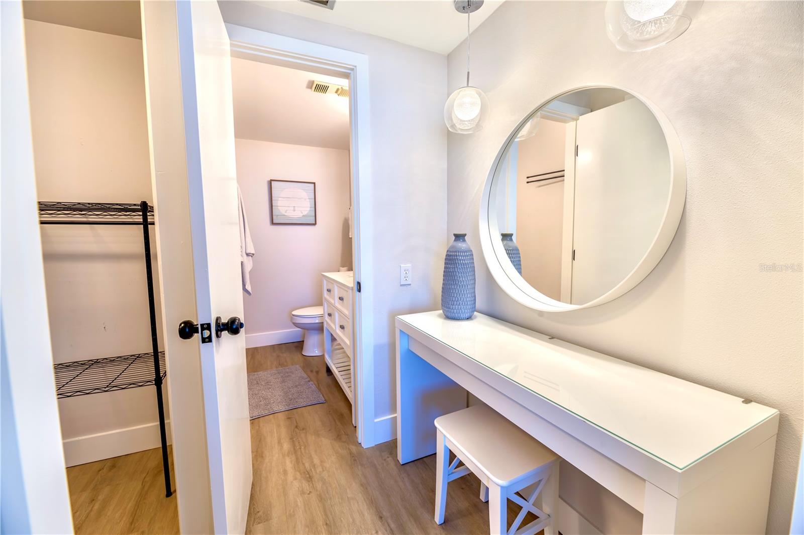 (Left to Right) Primary Closet leads into Separate Vanity into Toilet & Shower Room