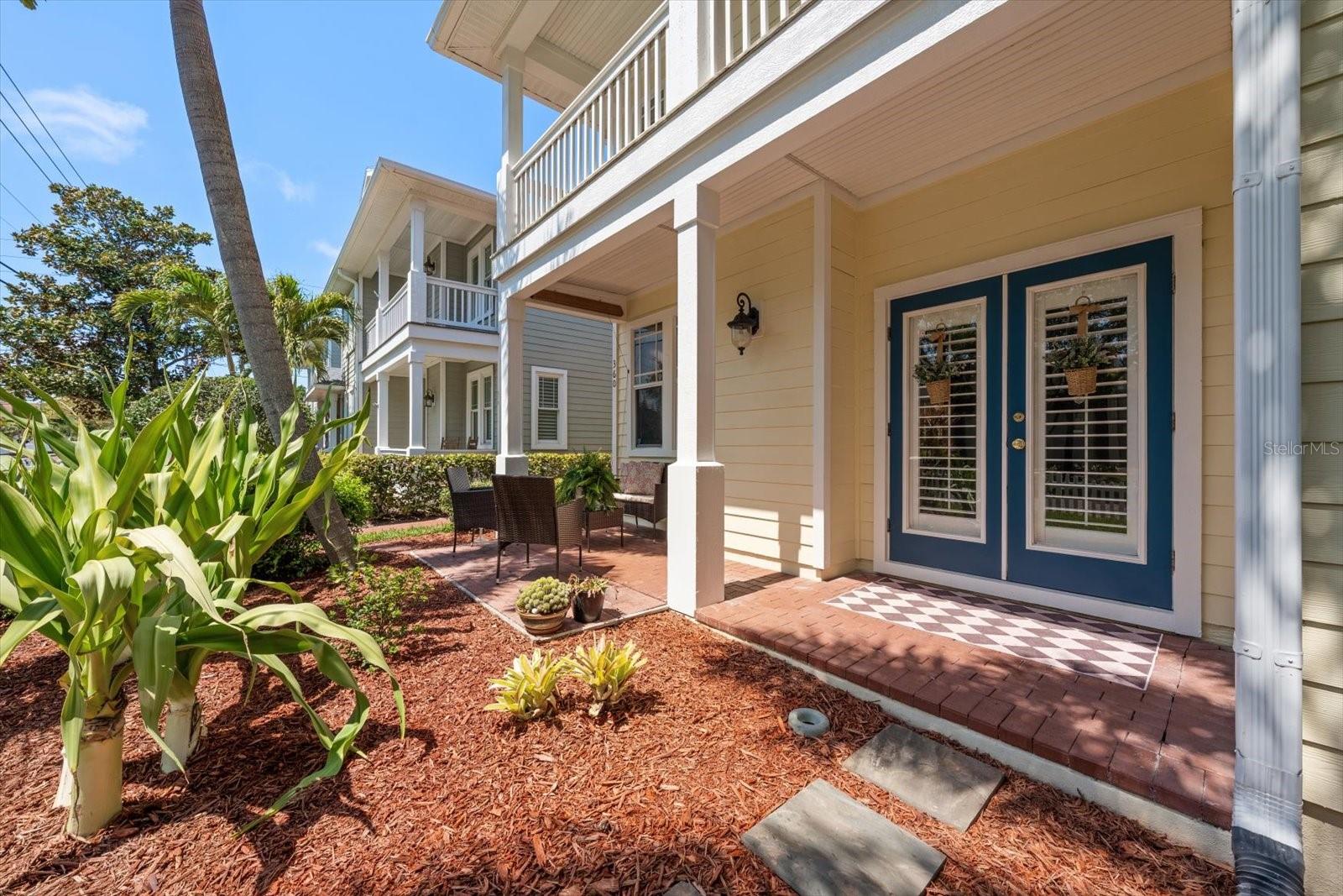 Large brick covered front patio, french doors