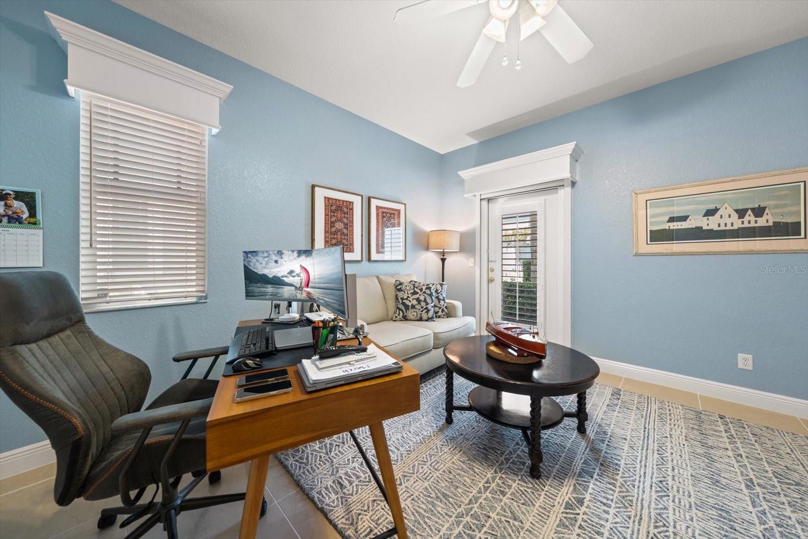 4th bedroom / flex space on main floor with door to back patio