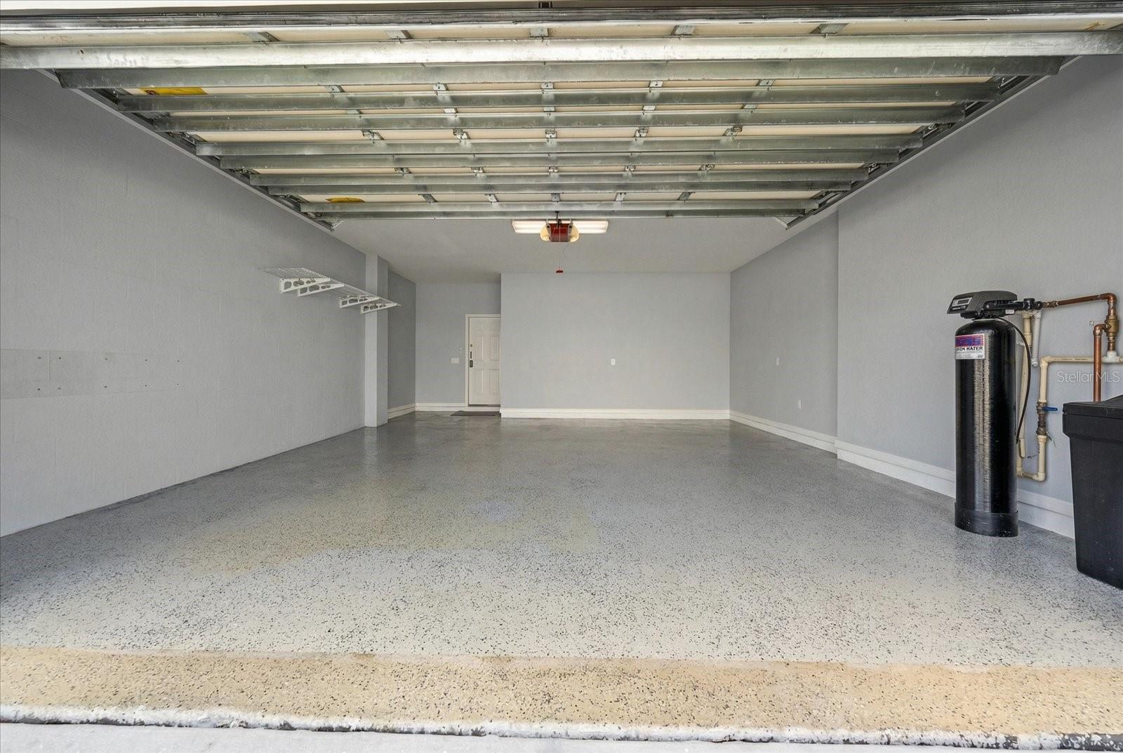 2 car garage with epoxy flooring, water softener and water treatment system, hurricane rate garage door and garage door opener