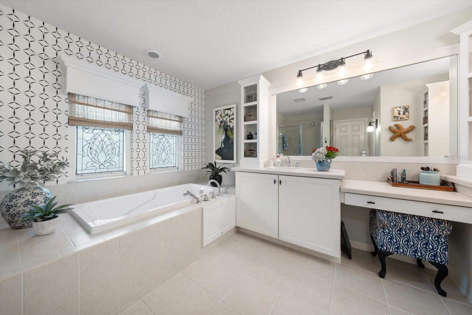 Primary en suite bathroom with vanity and garden tub