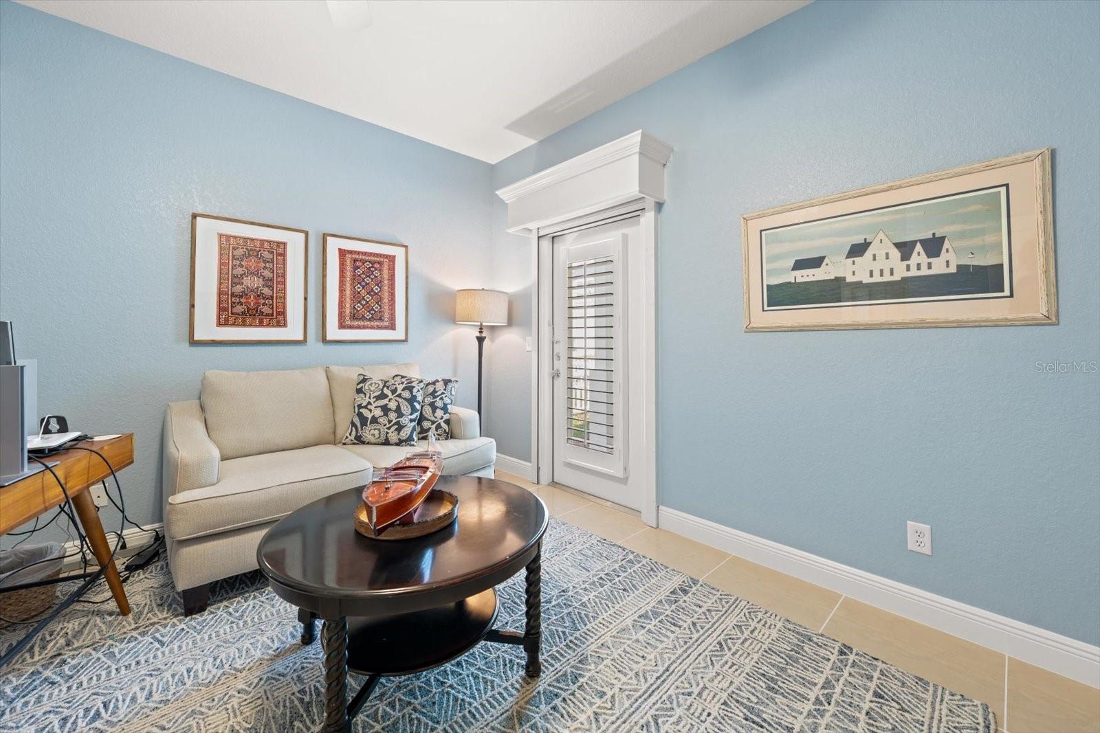 4th bedroom / flex space on main floor with door to back patio