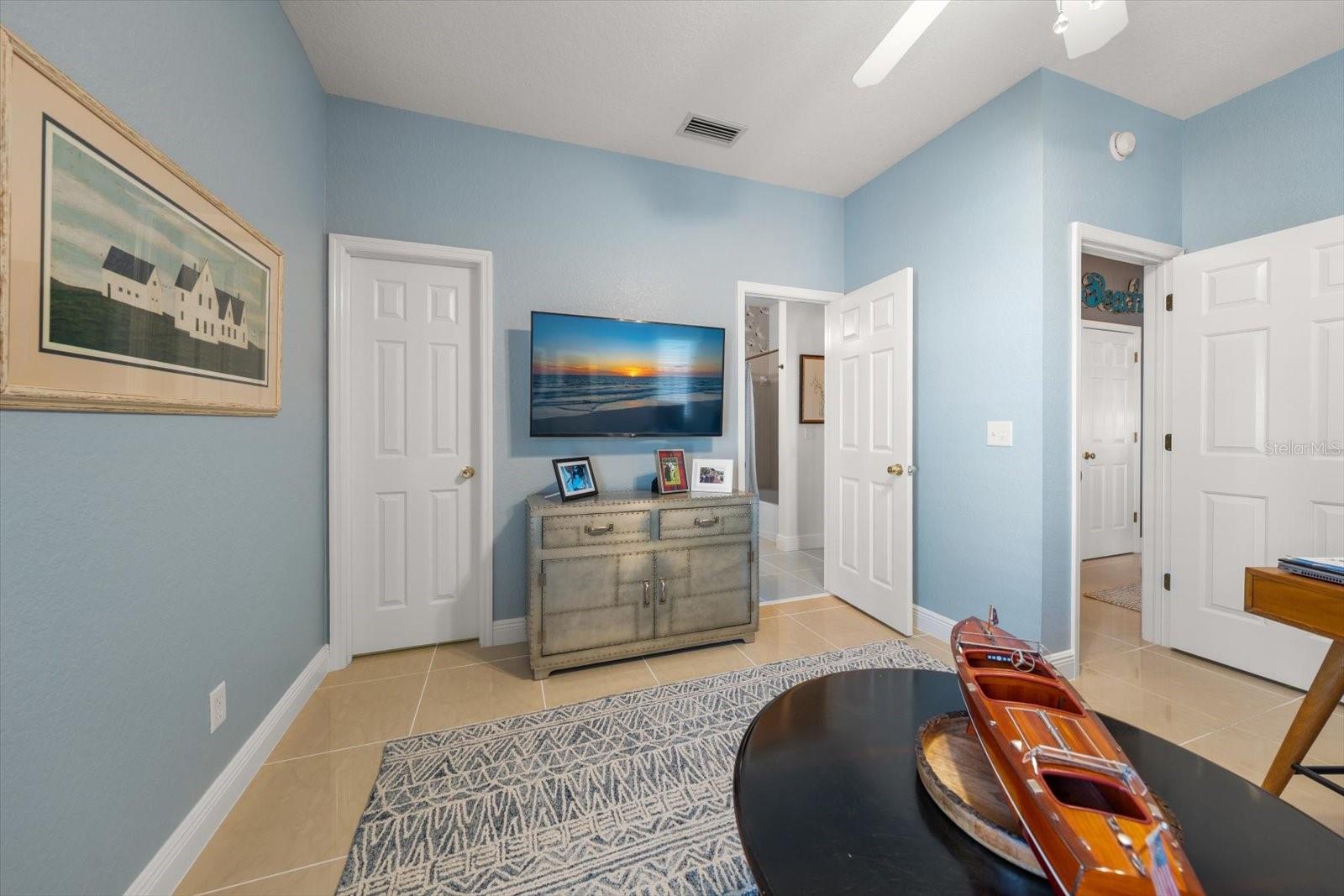 4th bedroom / flex space main floor with walk in closet, bathroom access and hallway access