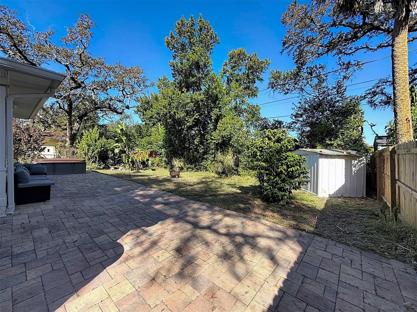 Brick paved patio and aluminum storage shed.