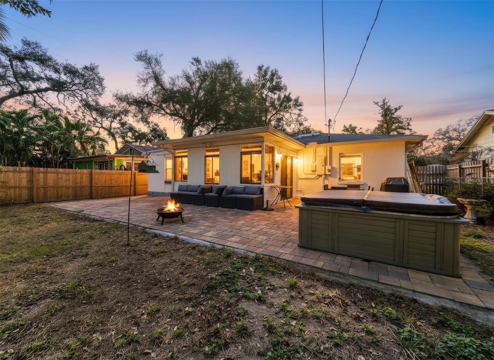 Enjoyment awaits in you hot tub on the spacious brick patio.