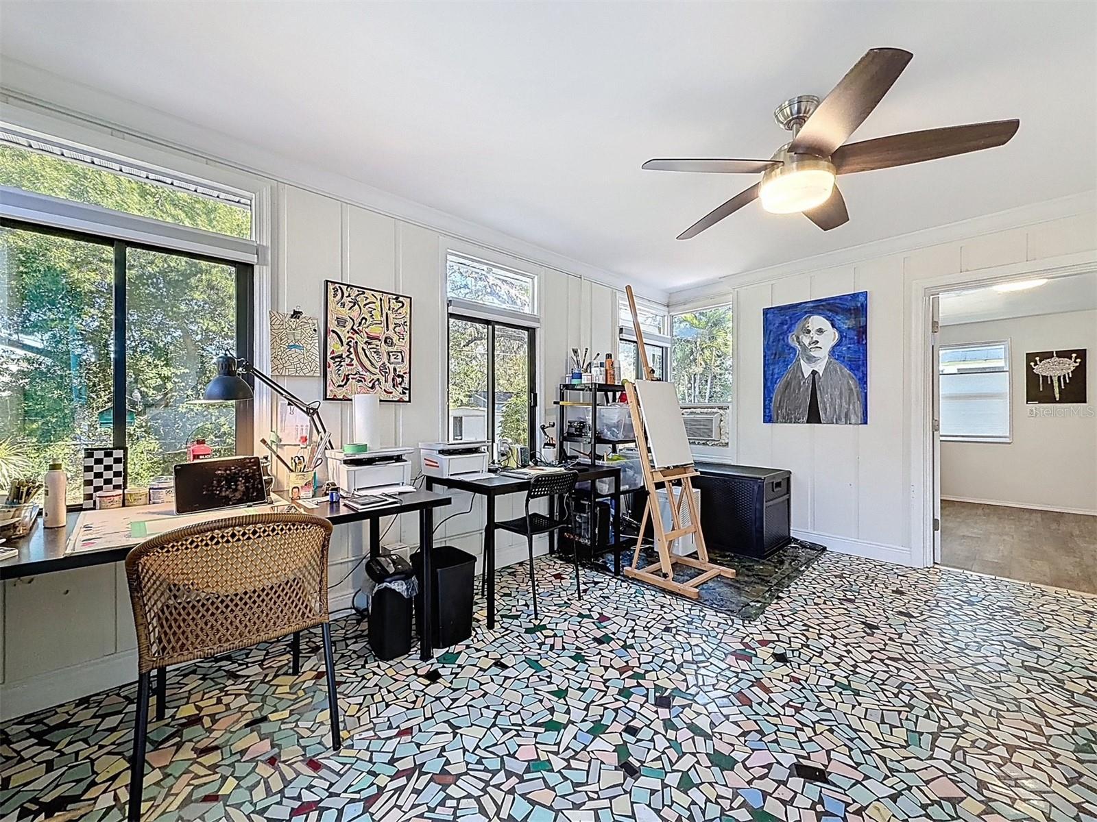 The art studio overlooks the cool, shady back yard.