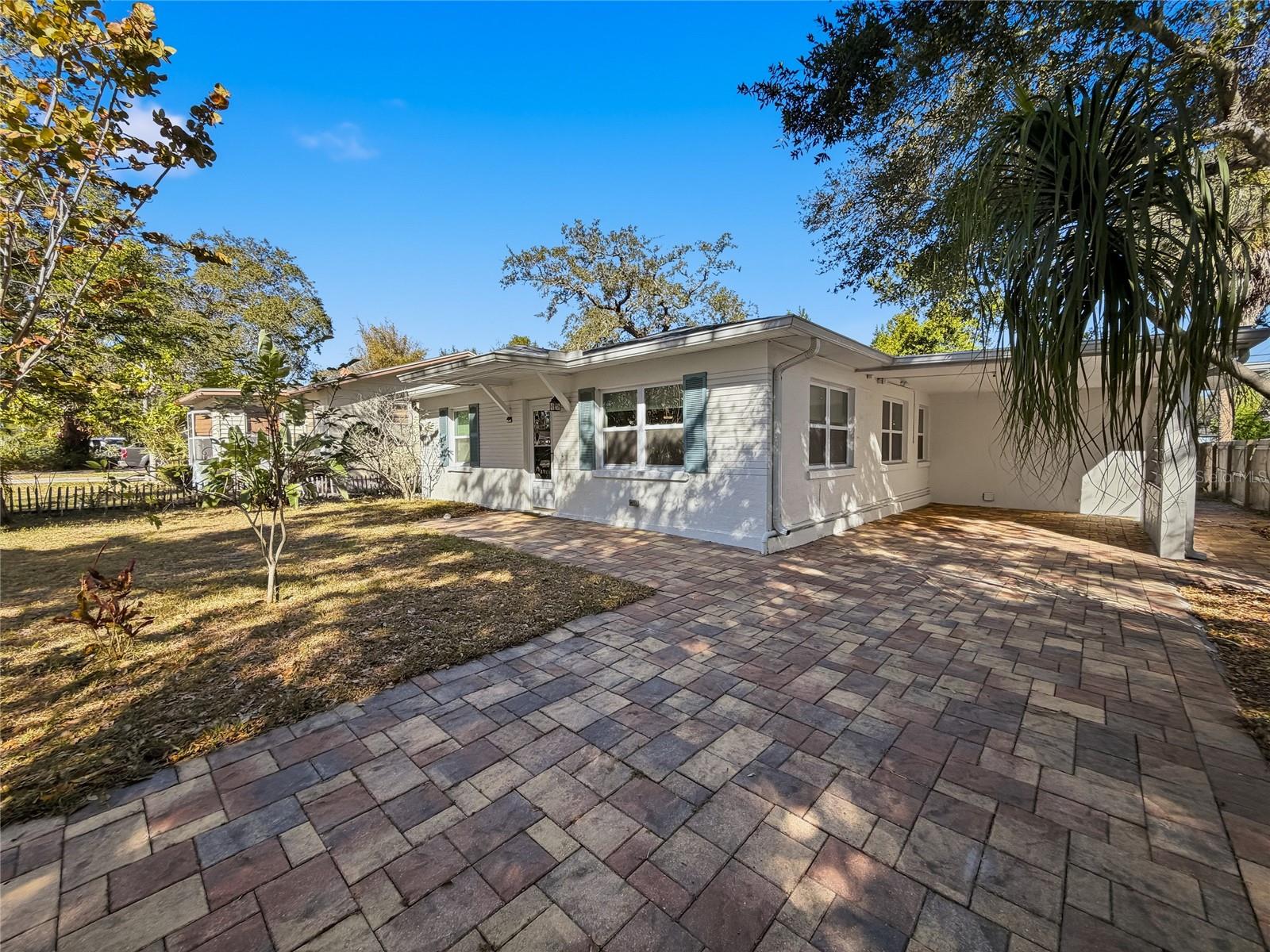 Brick paved driveway, carport and rear patio.