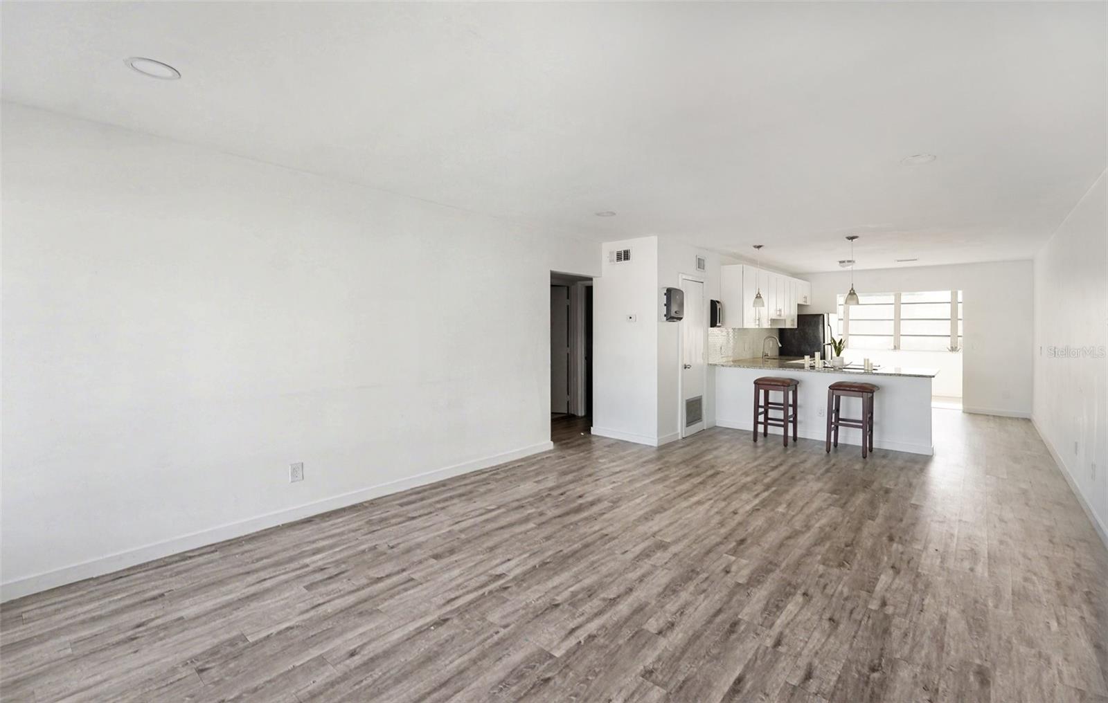 Open floor plan. Living room, dining room, kitchen. The kitchen opens up to a flex room, filled with natural light.