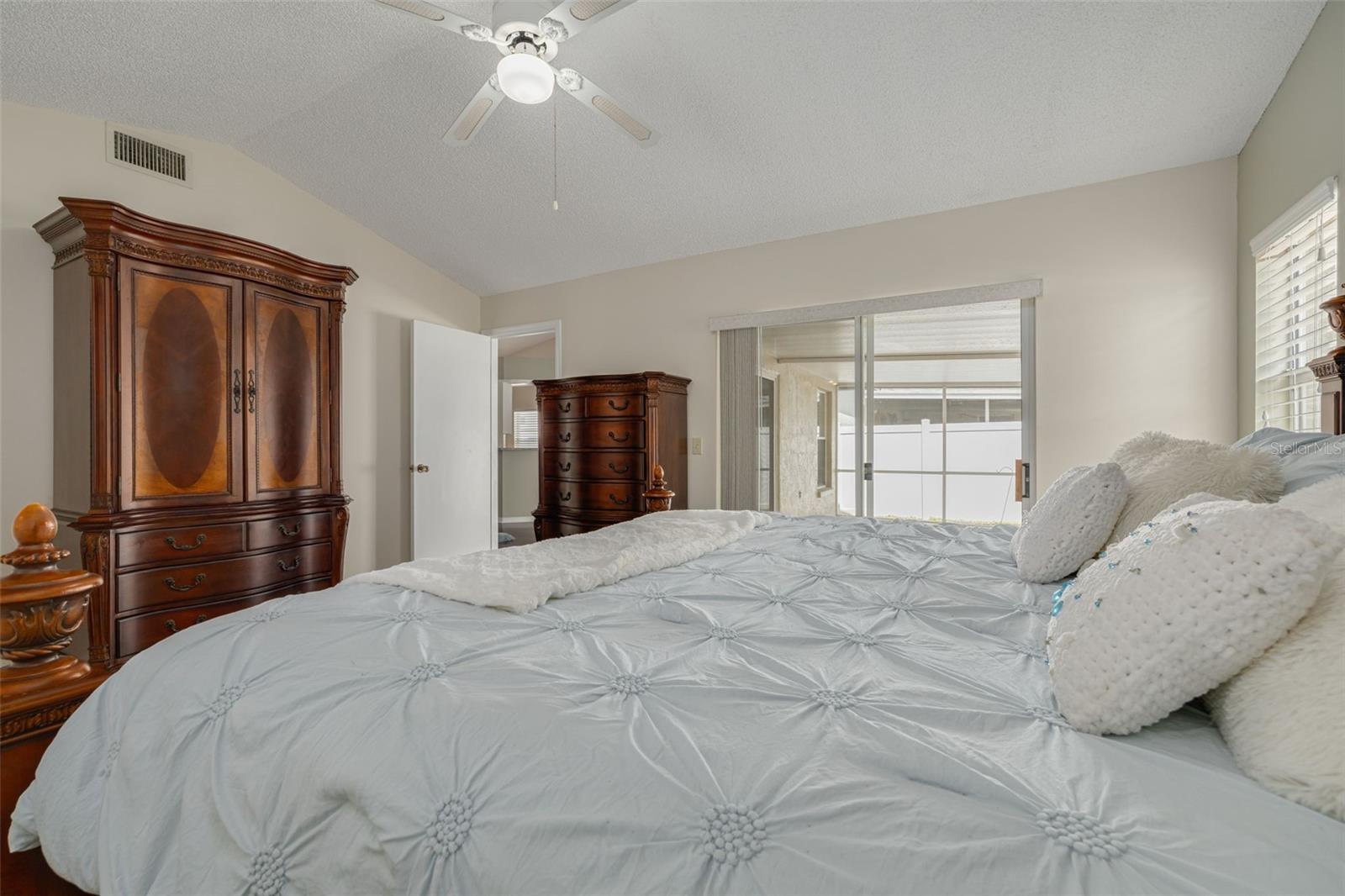 Primary bedroom with sliding doors to covered lanai