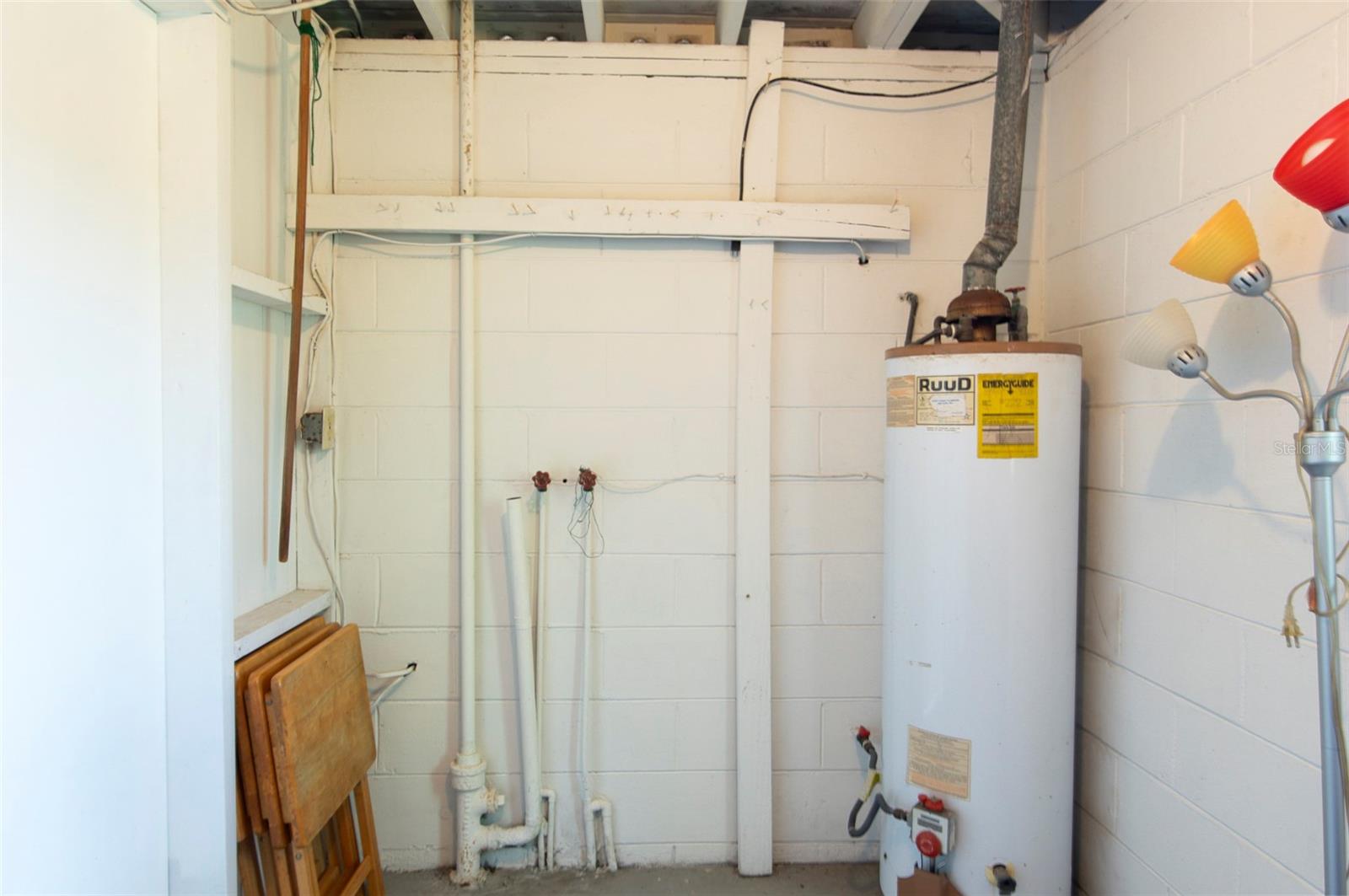 Washer & Dryer hookups in storage room under carport.