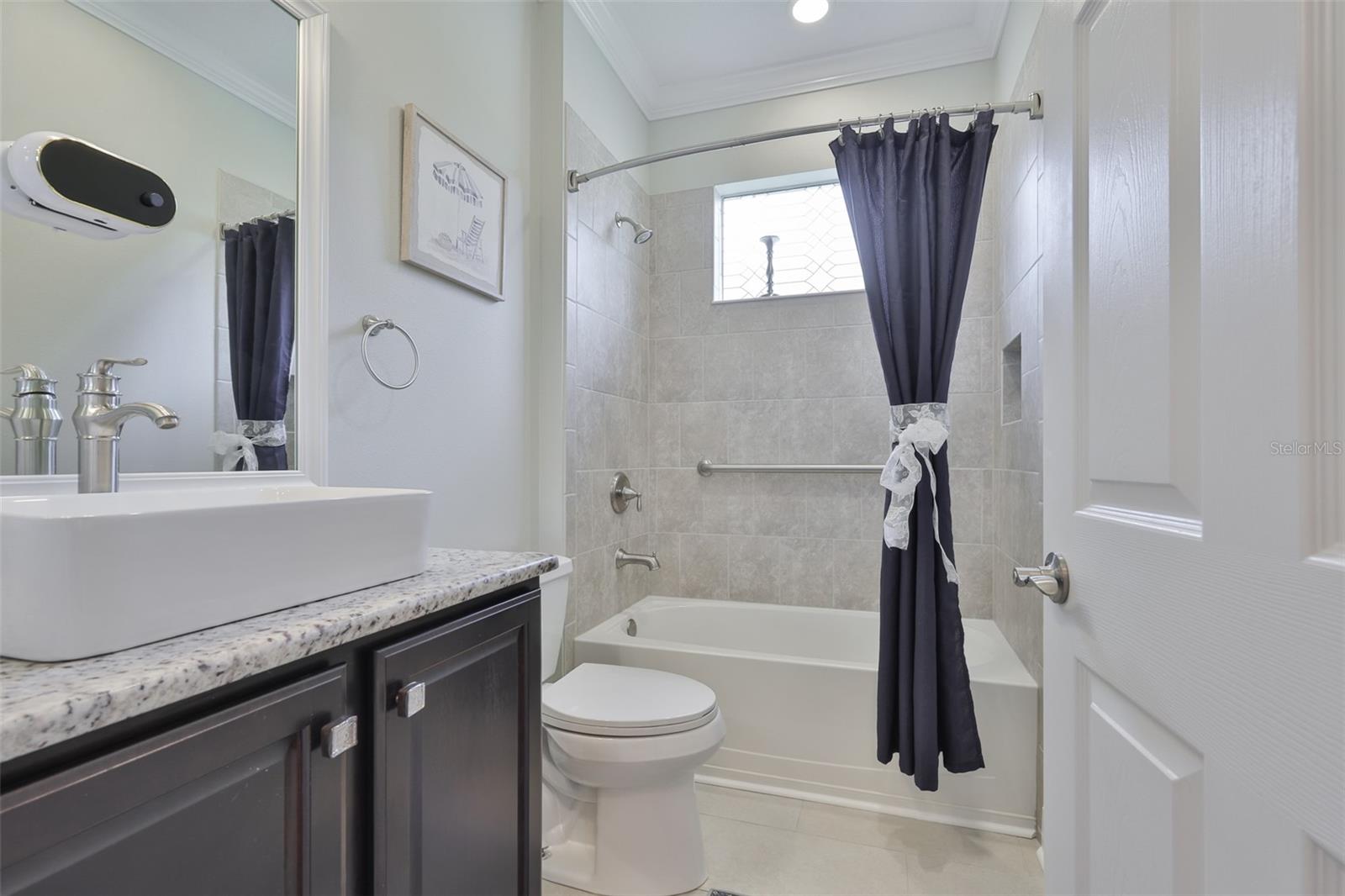 Guest bathroom matched the primary bathroom for consistency.  It is bright and clean.