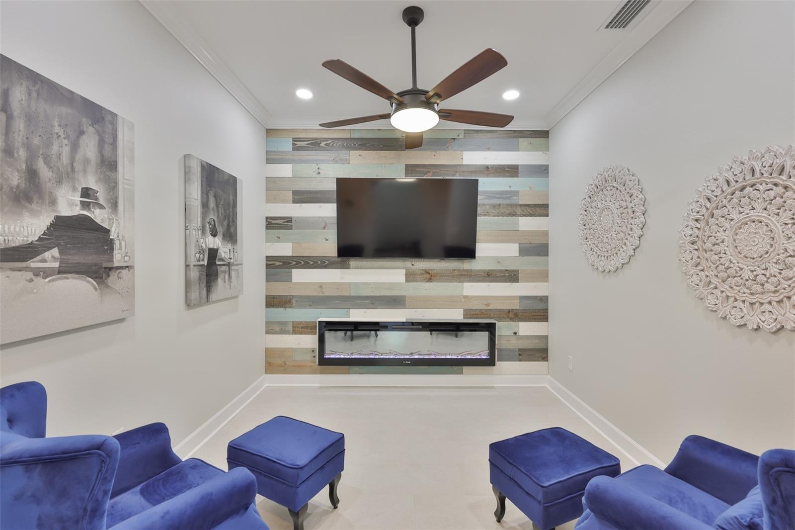 The den has been designed as a multi use room with a TV and electric fireplace for ultimate comfort.  Ntoice the crown molding, which is completely through out the home.