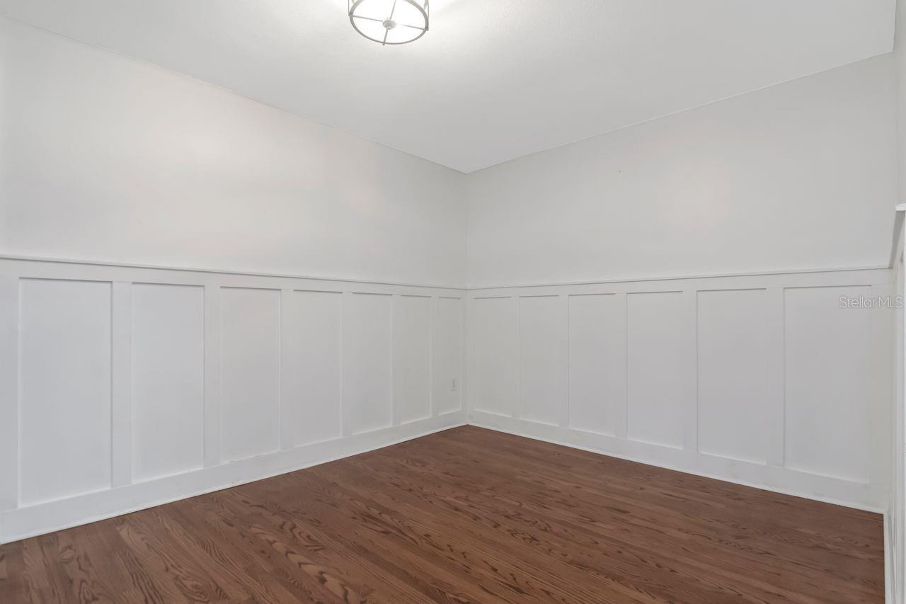 Formal Dining Room with custom wainscotting/border and Hardwood Floors.