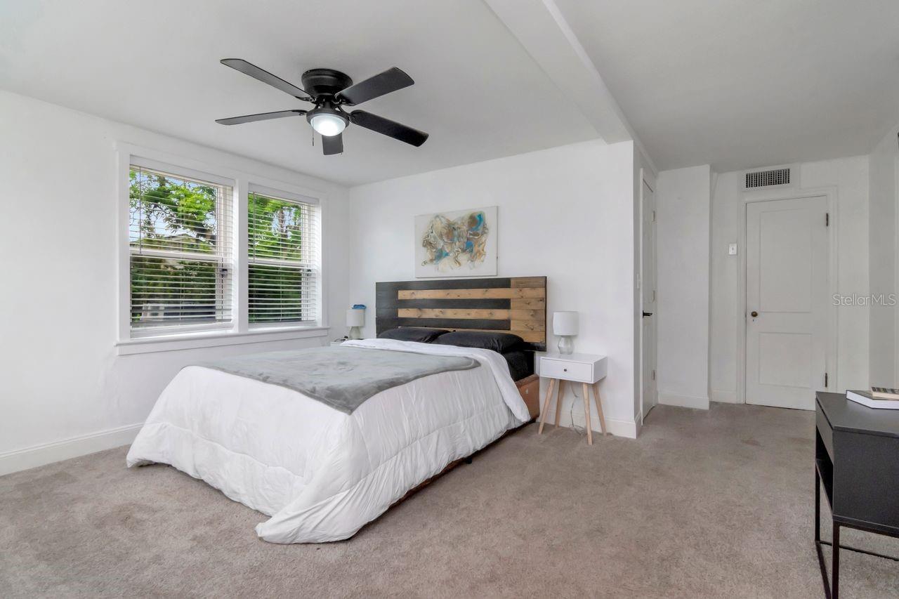 Primary Bedroom with New Carpet (04/08), En-Suite Bathroom, 2 Walk-In Closets, Plenty of Windows, Natural Light, Ceiling Fan.