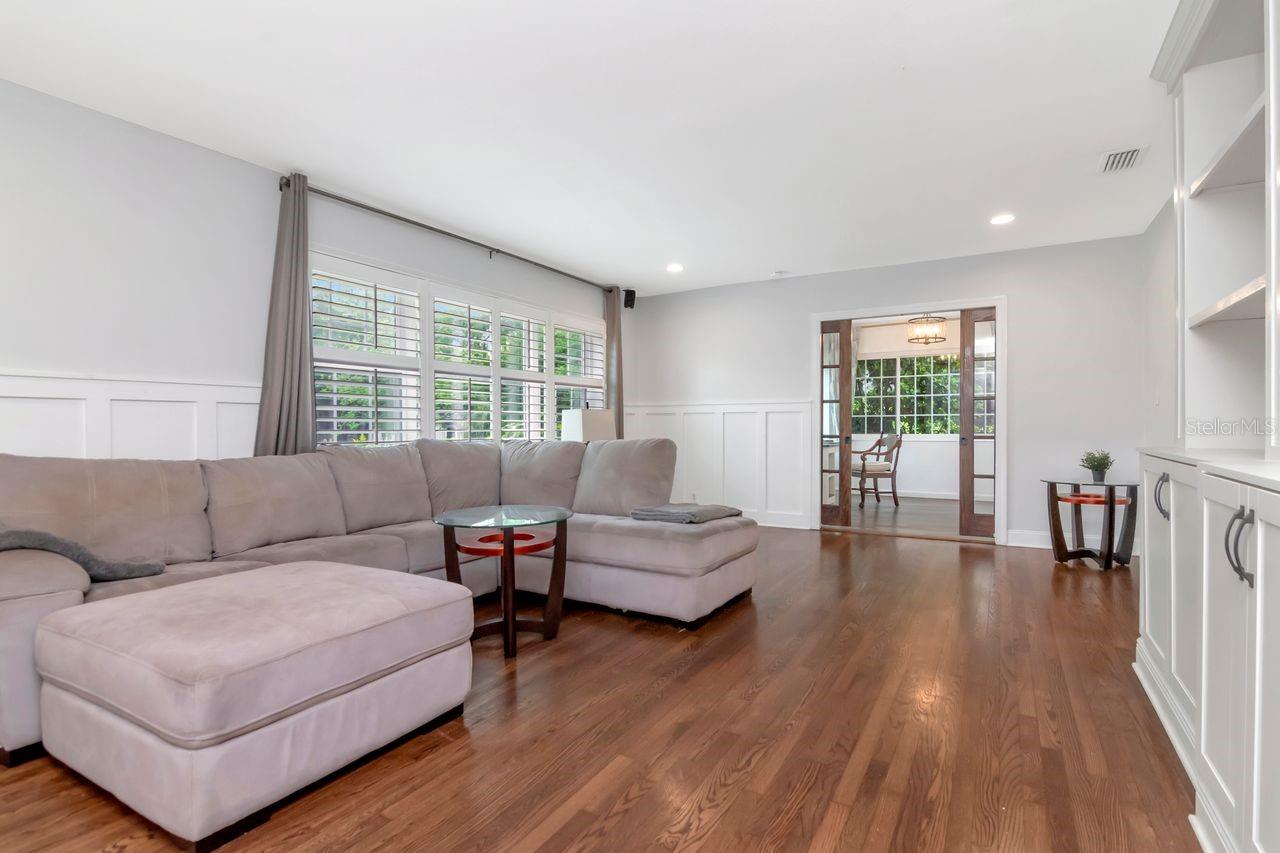 Living Room with Hardwood Floors, Natural Light, and Plantation Shutters